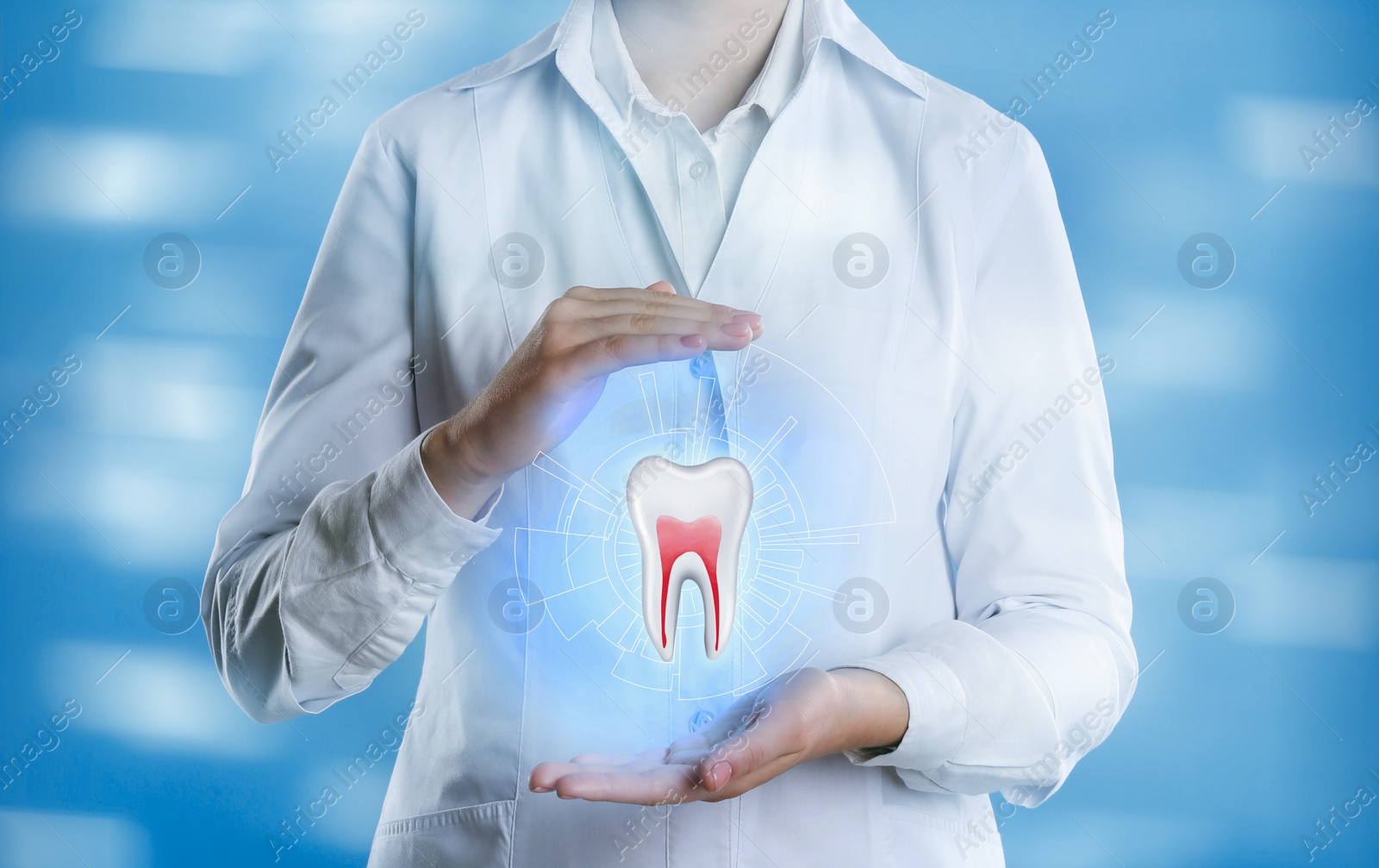 Image of Dentist showing virtual model of tooth on light blue background, closeup