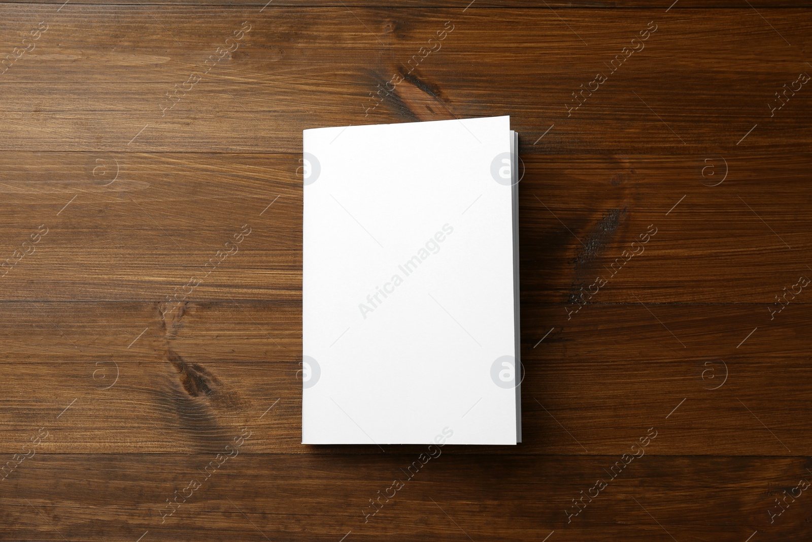 Photo of Blank paper brochure on wooden table, top view. Mockup for design