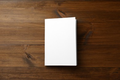 Blank paper brochure on wooden table, top view. Mockup for design