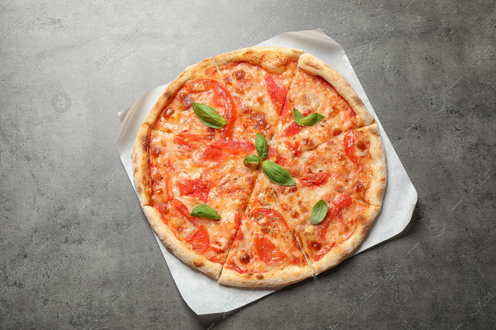 Photo of Delicious pizza Margherita on grey table, top view