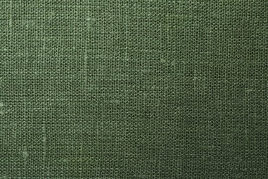 Photo of Texture of green fabric as background, top view