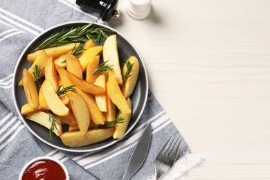 Photo of Plate with tasty baked potato wedges and rosemary on white wooden table, flat lay. Space for text