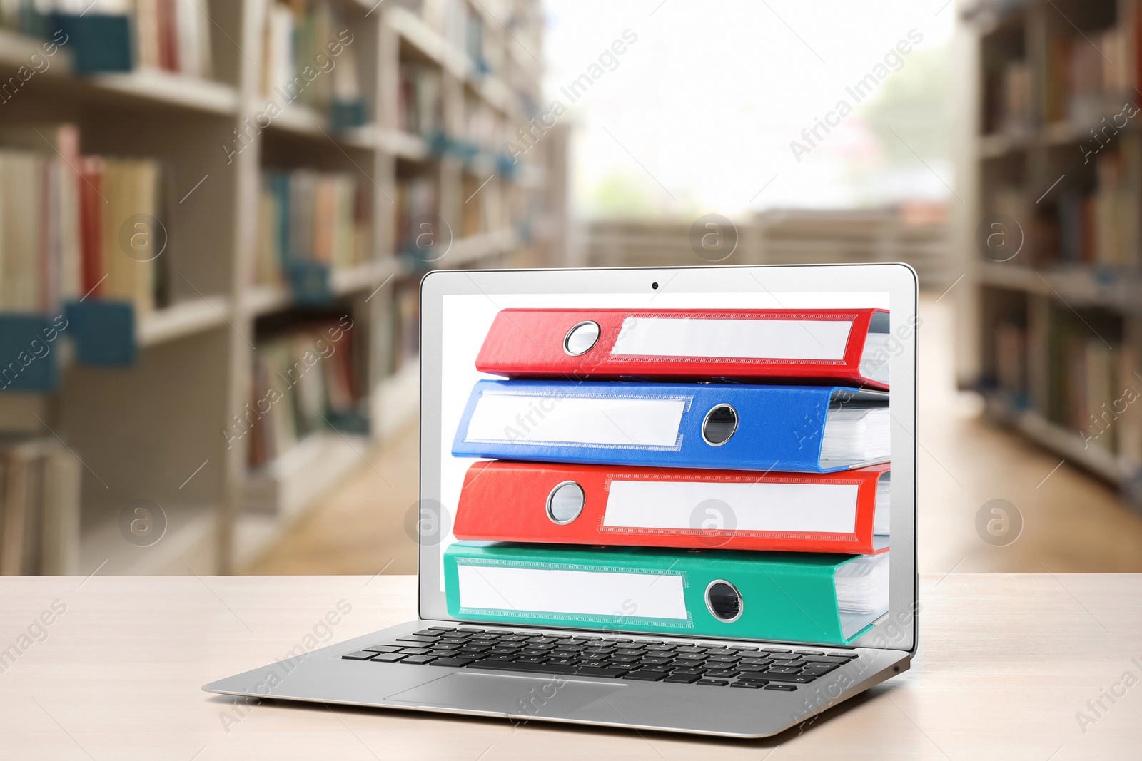 Image of Store and organize information. Hardcover office folders getting out of modern laptop in archive room