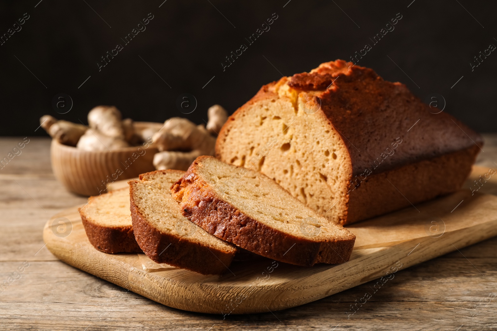 Photo of Sliced delicious gingerbread cake on wooden table
