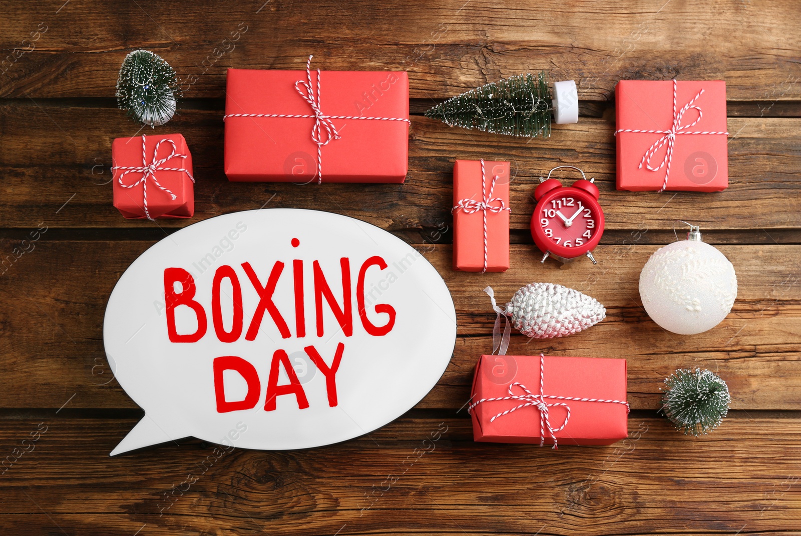 Photo of Flat lay composition with Boxing Day sign and Christmas gifts on wooden table