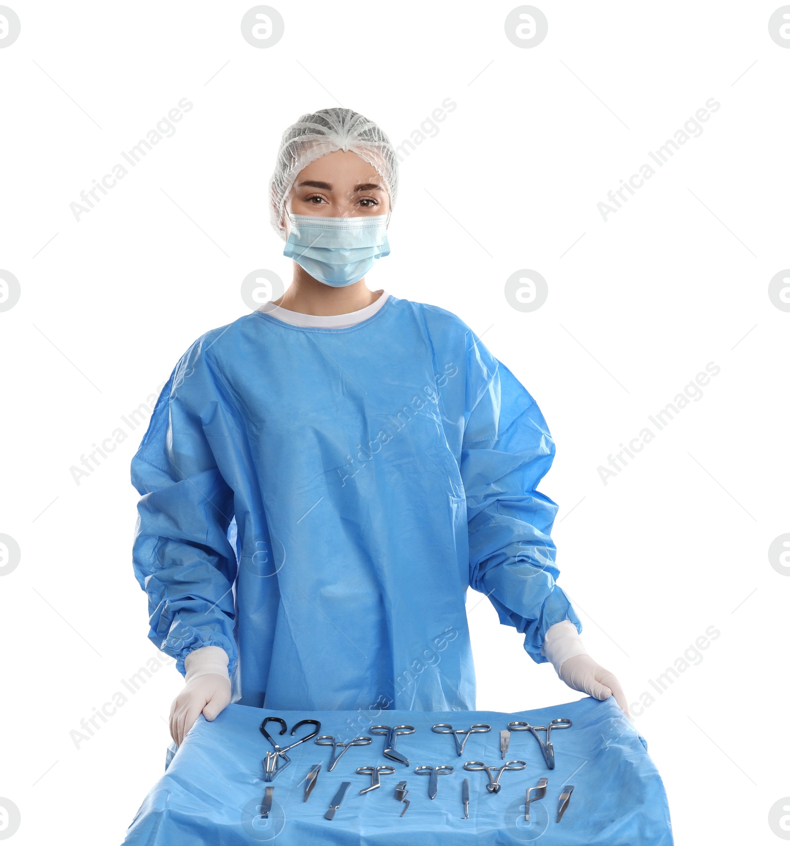 Photo of Doctor near table with surgical instruments on light background
