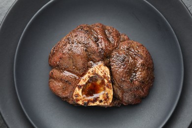Photo of Piece of tasty grilled beef meat on plate, top view