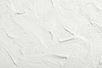 Photo of Texture of white oil paint as background, closeup