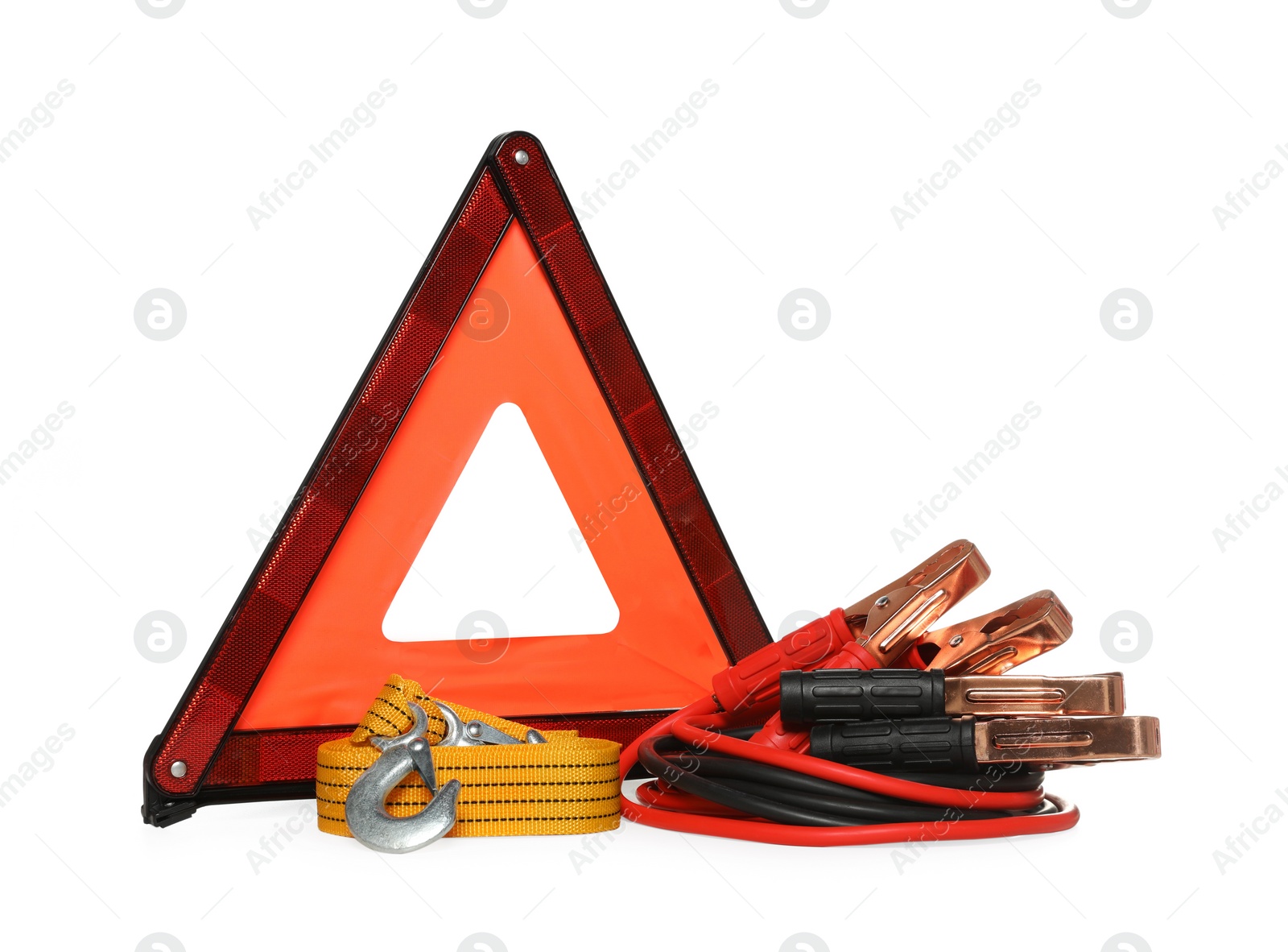 Photo of Emergency warning triangle, towing strap and battery jumper cables on white background. Car safety