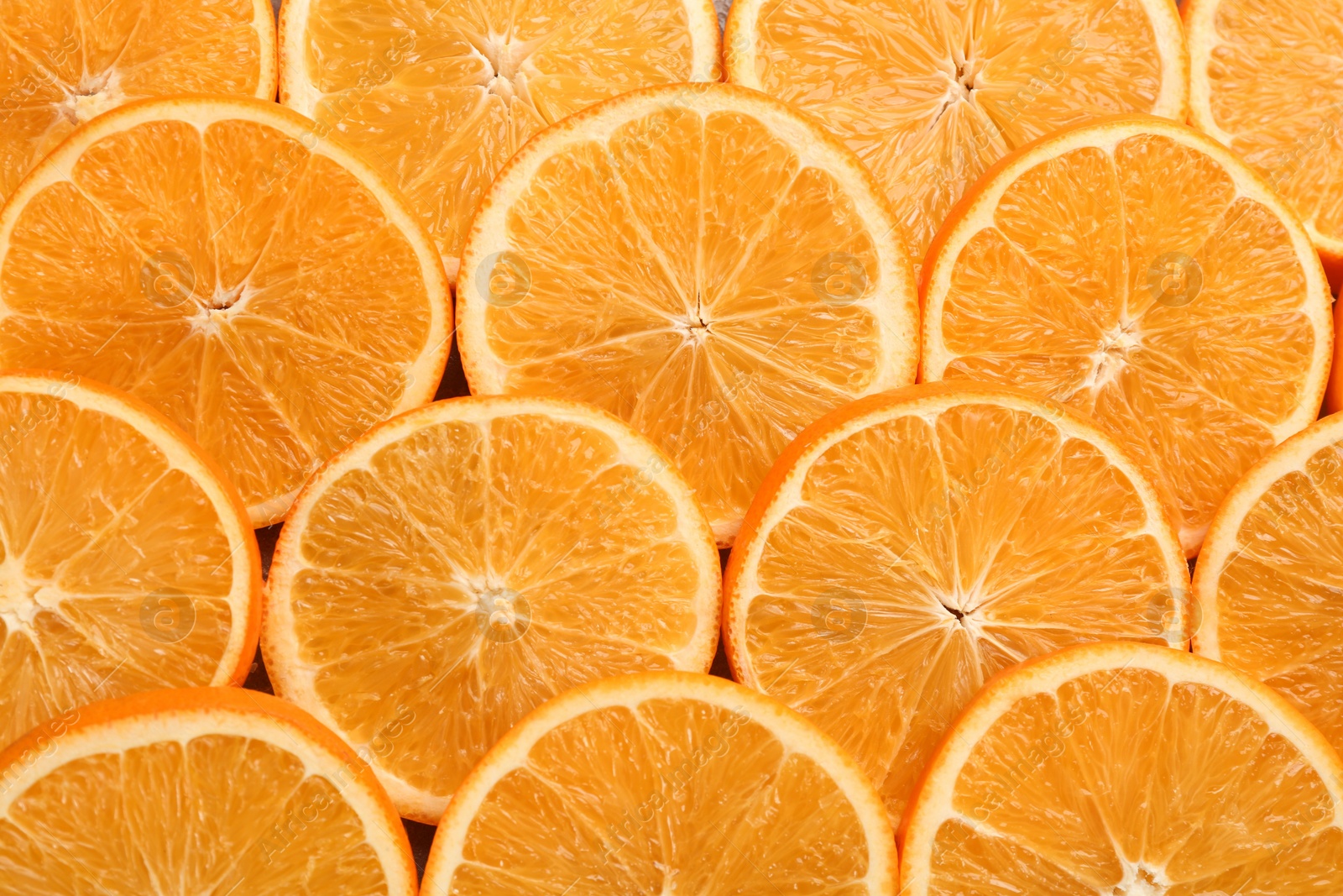 Photo of Slices of delicious oranges as background, closeup