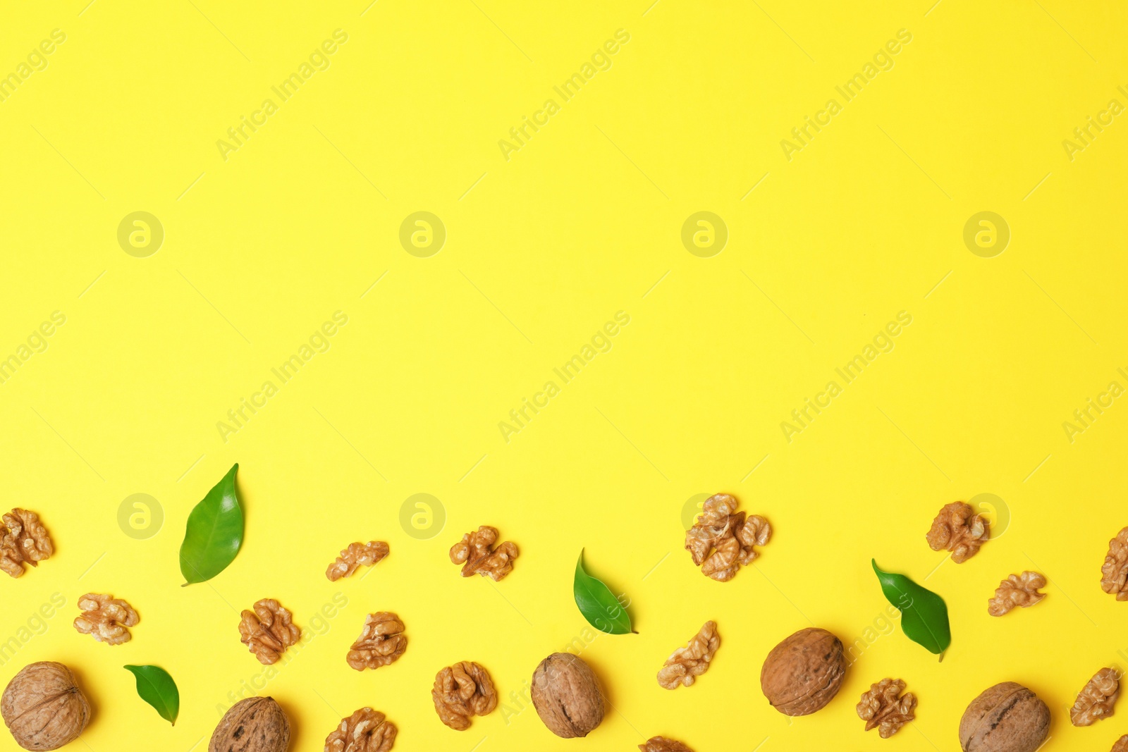 Photo of Flat lay composition with walnuts and space for text on color background