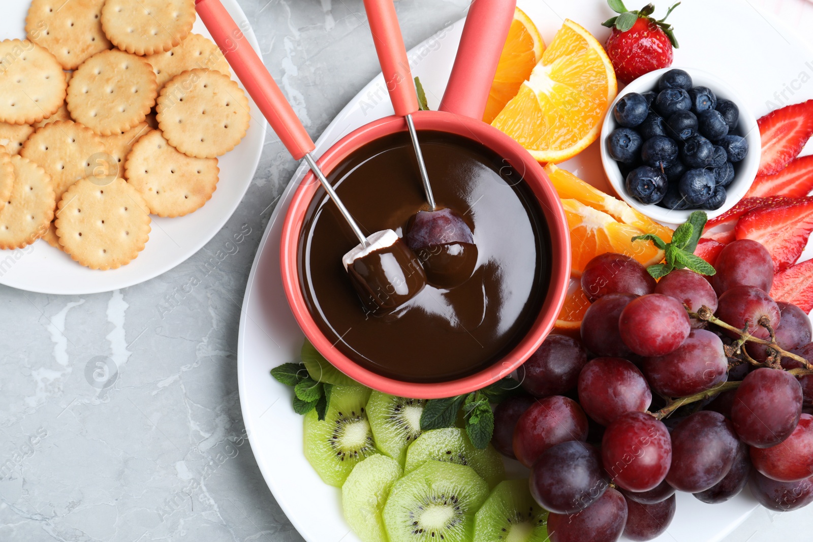 Photo of Flat lay composition with chocolate fondue on grey background