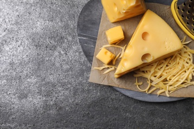 Photo of Tasty fresh cheese on grey table, top view. Space for text