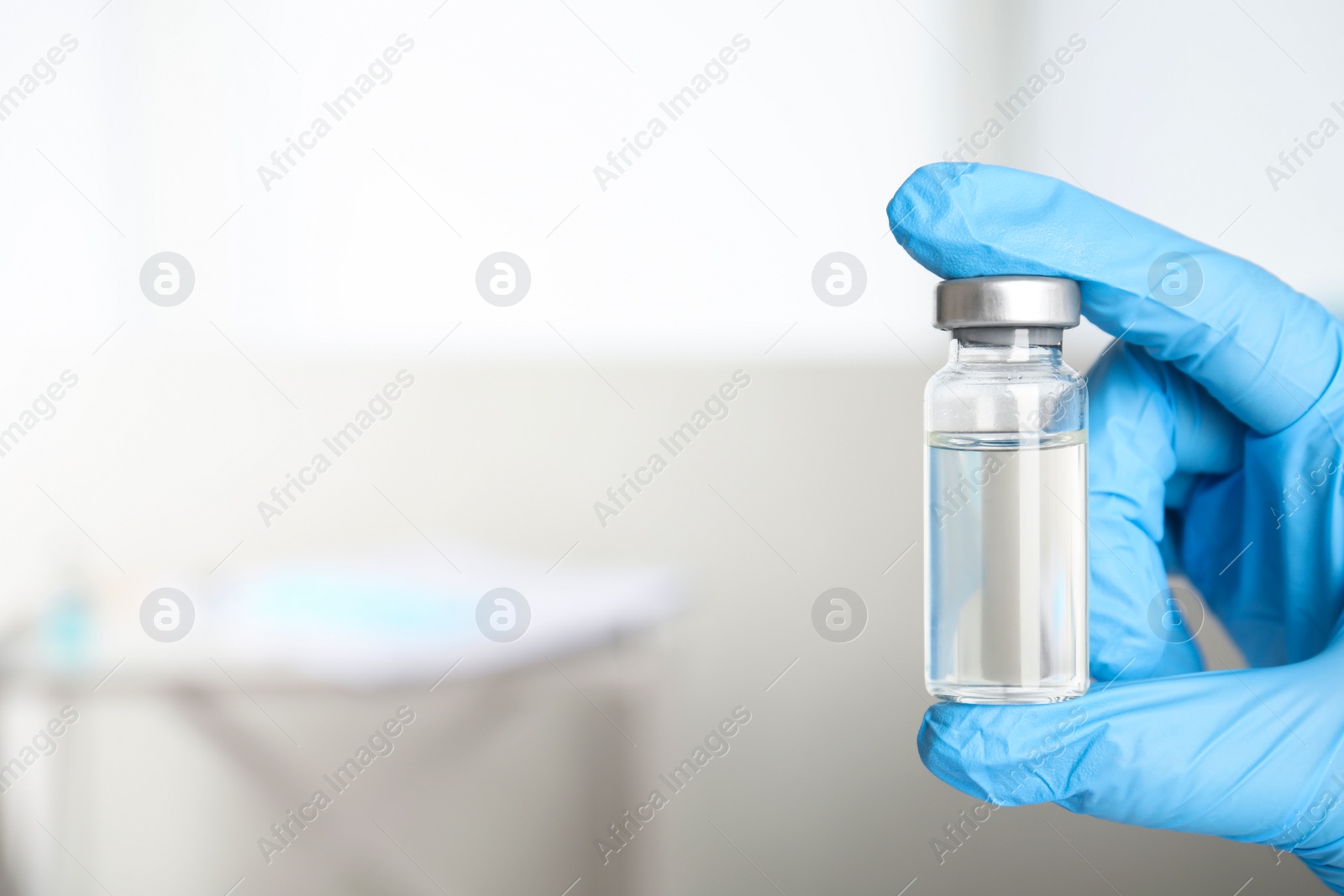 Photo of Doctor holding vial with medication, closeup view and space for text. Vaccination and immunization