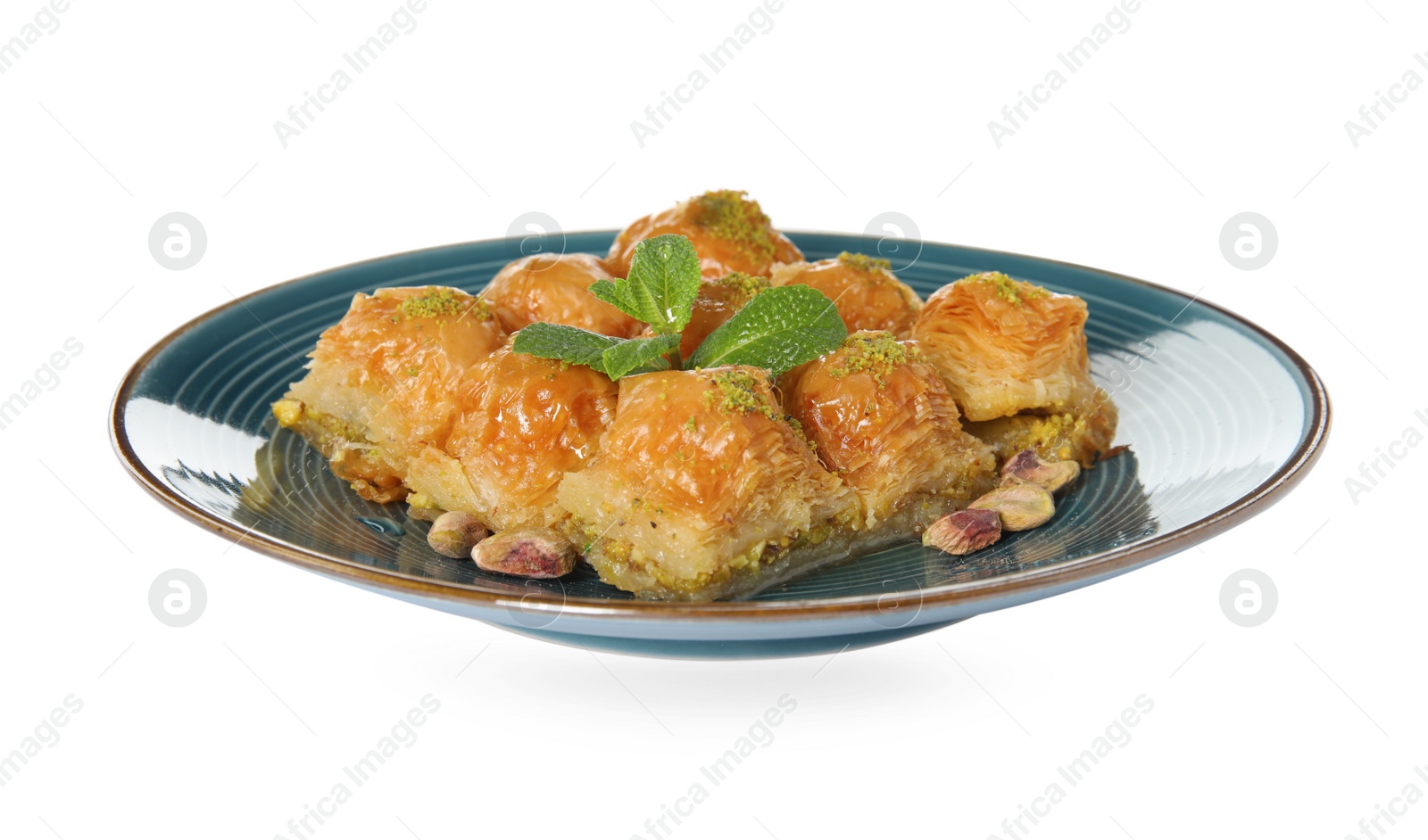 Photo of Plate of delicious baklava with pistachio nuts and mint on white background