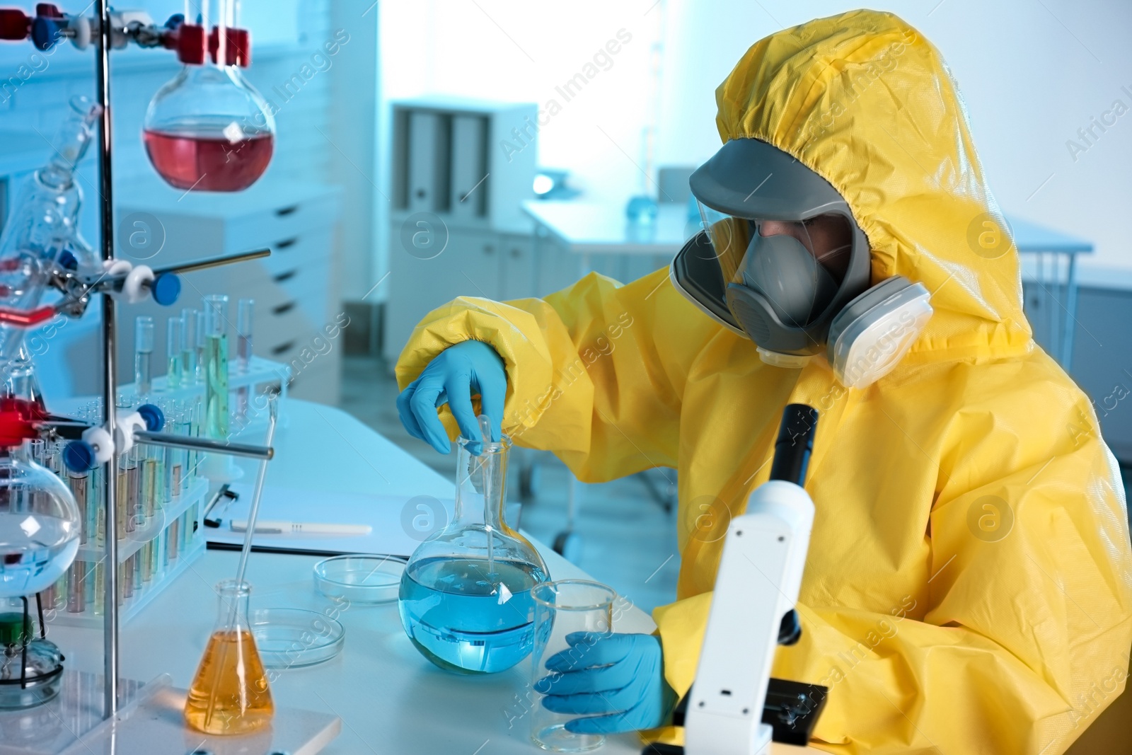 Photo of Scientist in chemical protective suit working at laboratory. Virus research