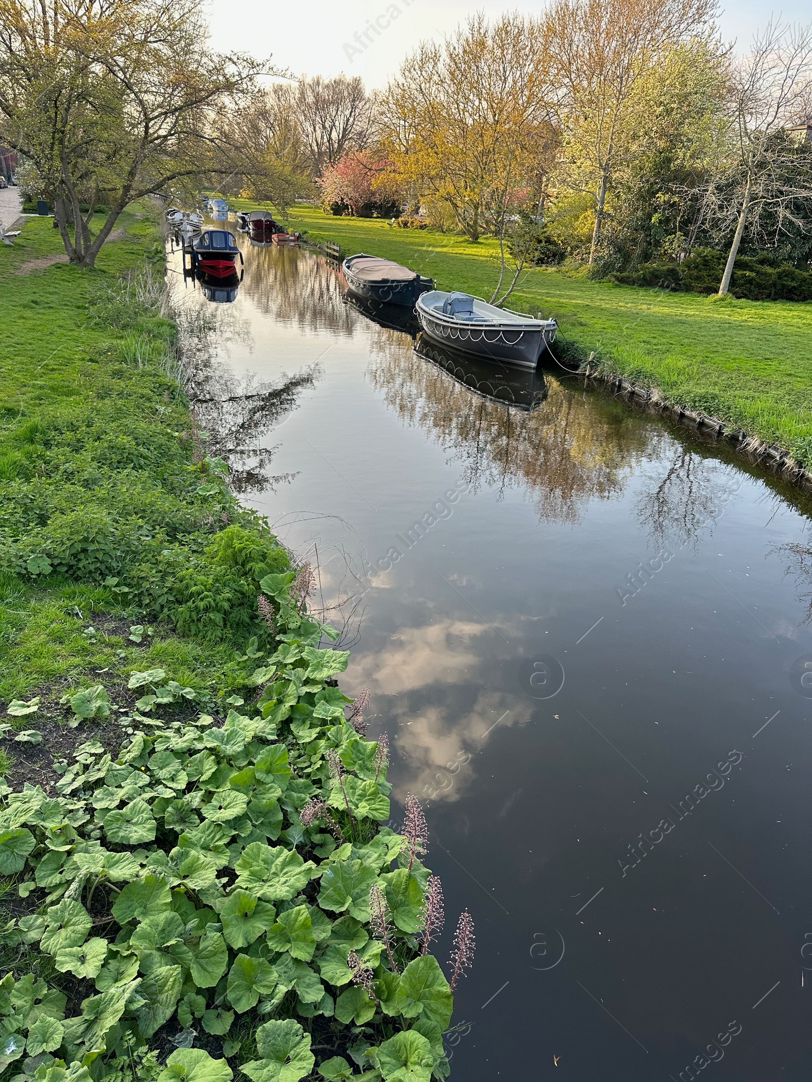 Photo of Beautiful view of canal with moored boats in city