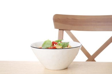 Photo of Delicious fusilli pasta with tomatoes served on wooden table