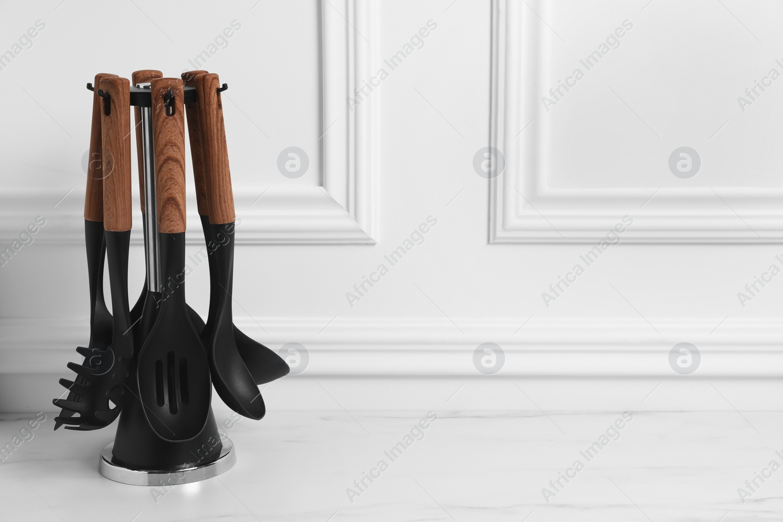Photo of Set of different kitchen utensils on white table, space for text