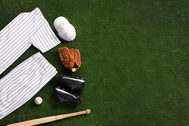 Flat lay composition with baseball equipment on artificial grass. Space for text