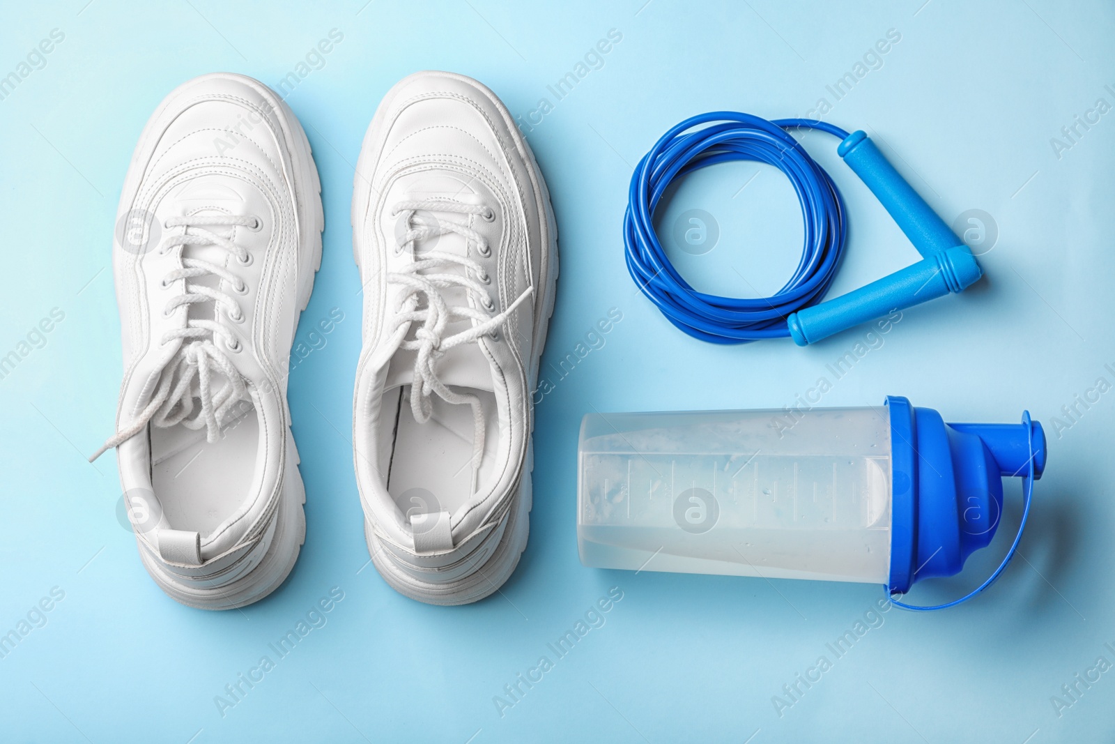 Photo of Flat lay composition with jump rope on color background