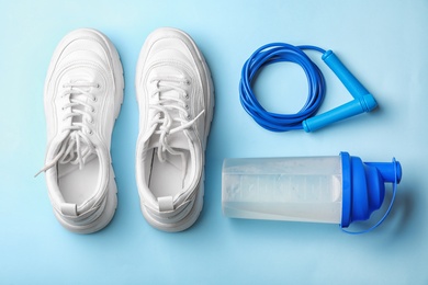 Photo of Flat lay composition with jump rope on color background