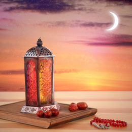 Image of Traditional Ramadan lantern, dates and prayer beads on table. Muslim holiday