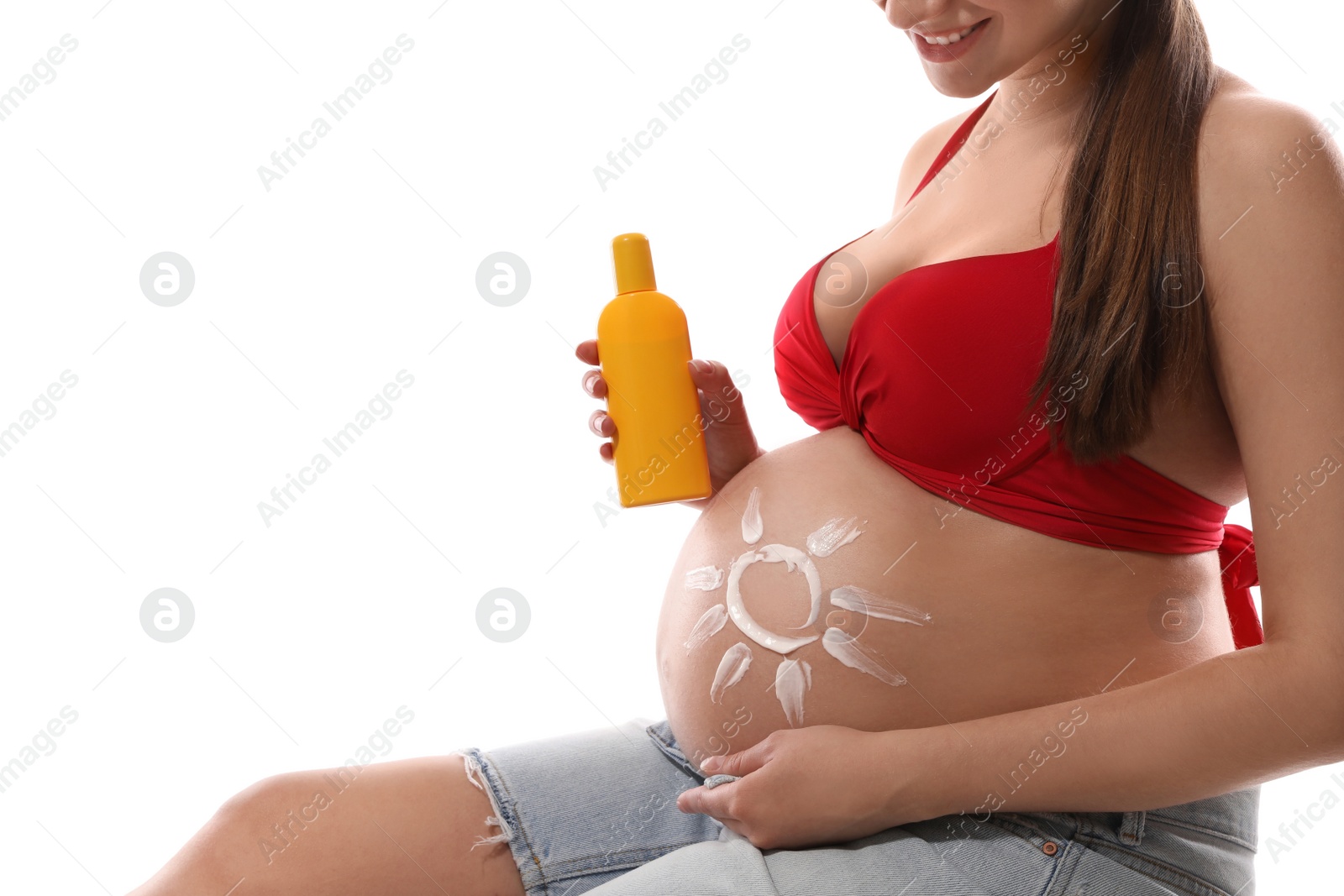 Photo of Young pregnant woman with sun protection cream on white background, closeup