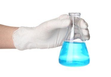 Scientist in gloves holding laboratory flask with light blue liquid on white background, closeup