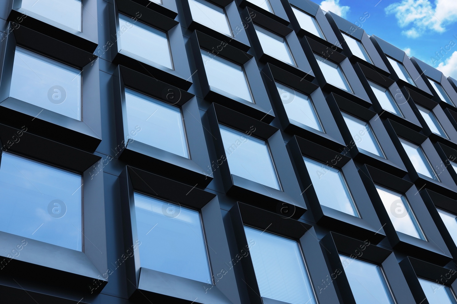 Photo of Building with tinted windows, outdoors. Modern architectural design