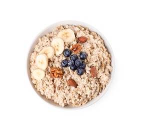 Photo of Tasty boiled oatmeal with banana, blueberries and nuts in bowl isolated on white, top view