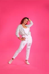 Photo of Beautiful Hispanic woman posing on pink background