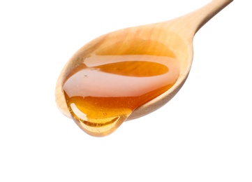 Photo of Honey dripping from spoon on white background