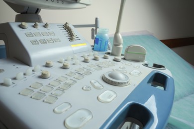 Ultrasound control panel and examination table in hospital, closeup