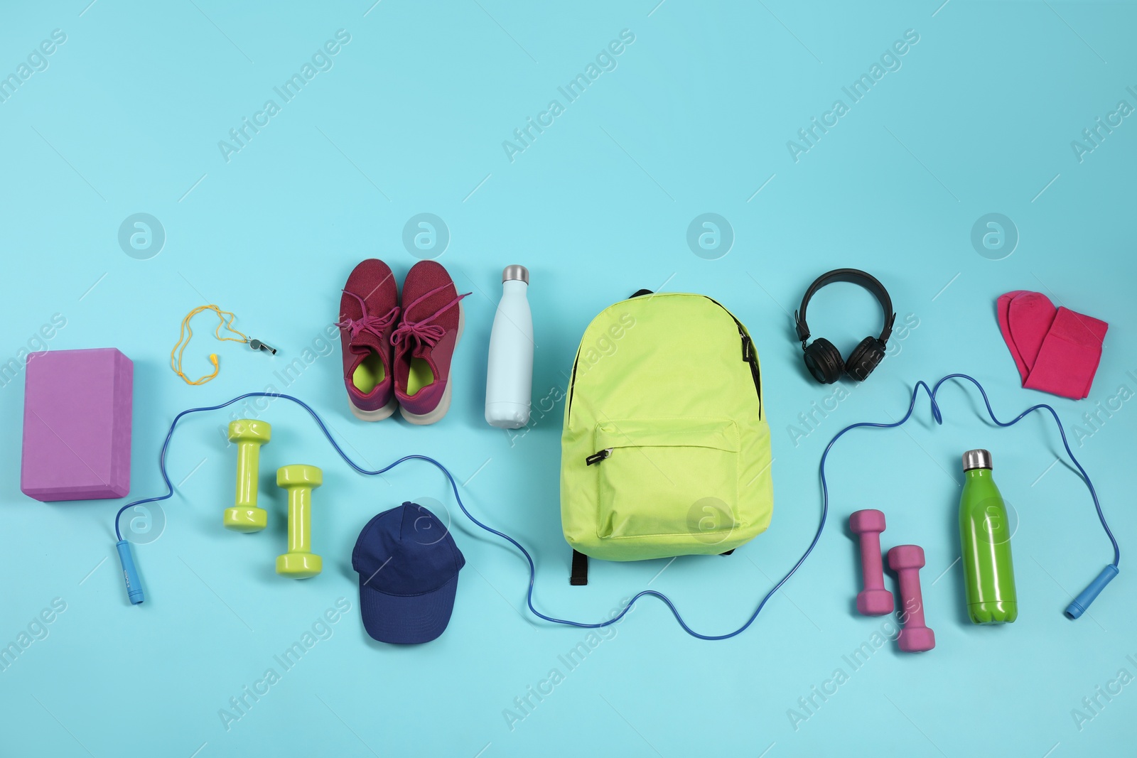 Photo of Different sports equipment on light blue background, flat lay