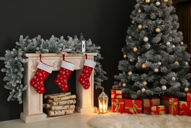 Stylish Christmas interior with decorated fir tree and fireplace