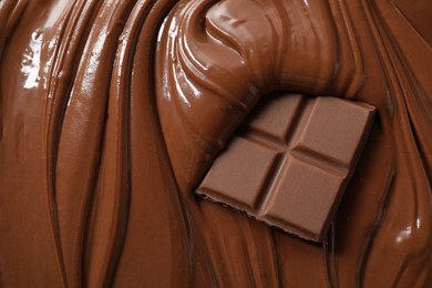 Photo of Tasty milk chocolate paste and pieces as background, top view