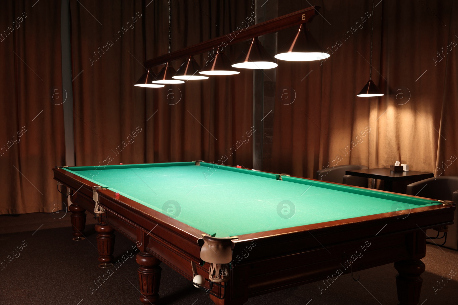 Photo of Empty green billiard table in club. Pool Game