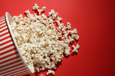 Delicious popcorn on red background, top view