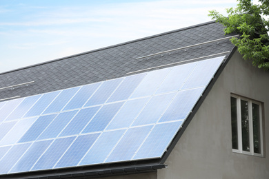 House with installed solar panels on roof. Alternative energy source