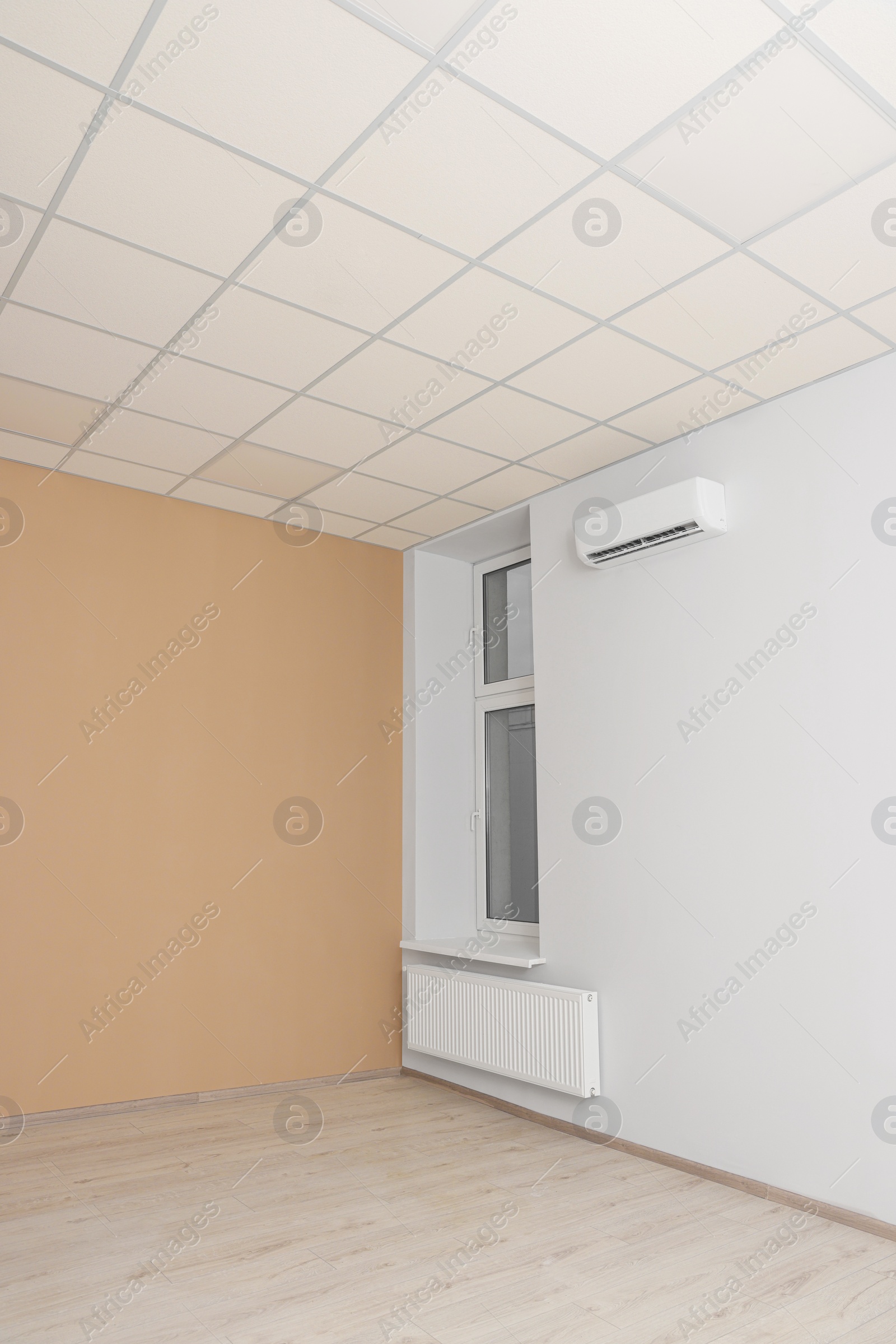 Photo of New empty office room with clean window and beige wall