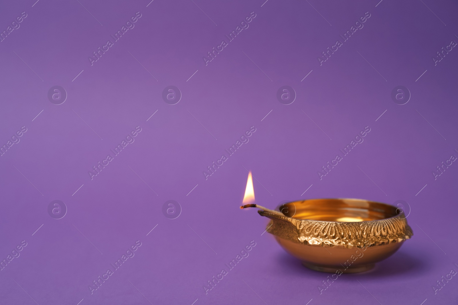 Photo of Diwali diya or clay lamp on color background