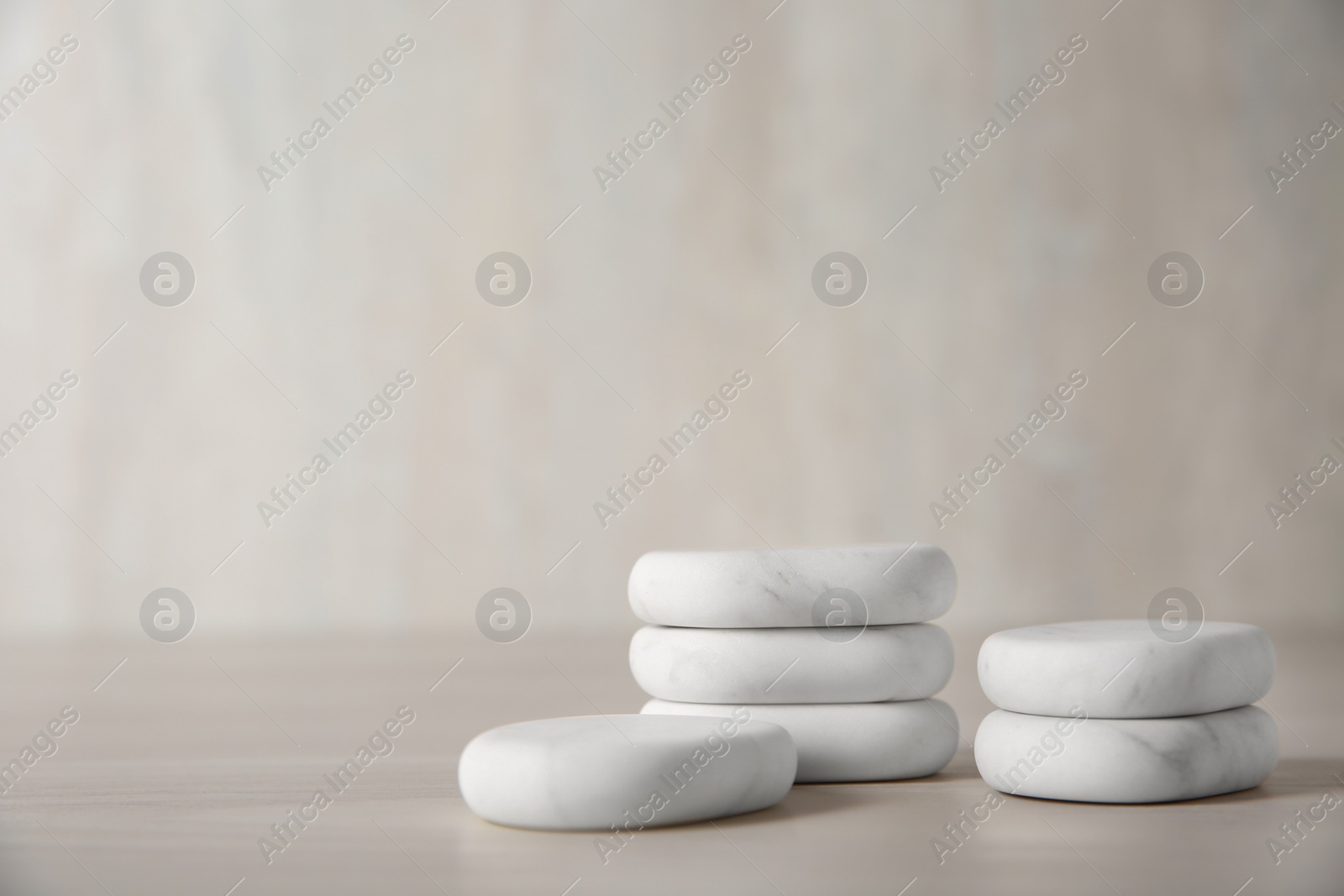 Photo of Marble spa stones on light background. Space for text