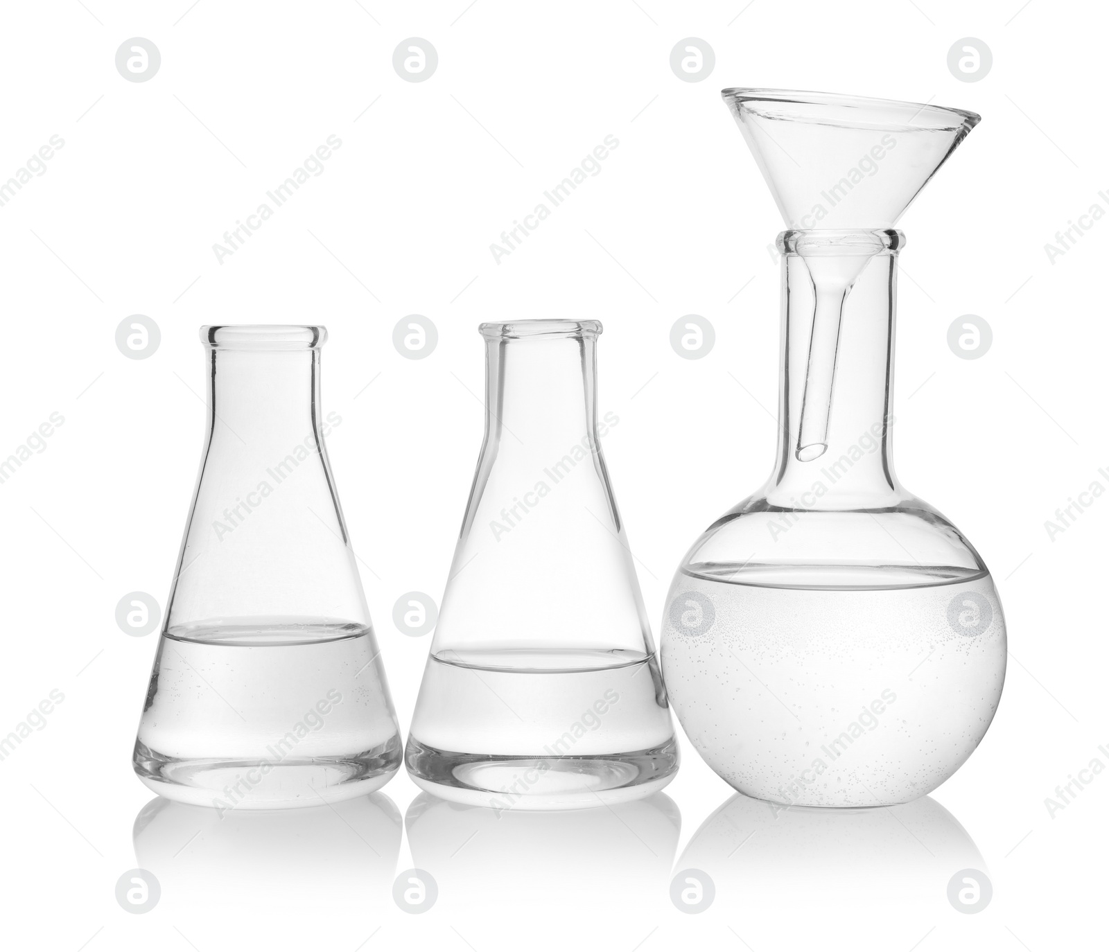 Photo of Laboratory glassware with transparent liquid on white background