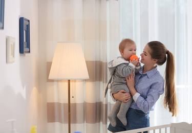 Photo of Teen nanny with cute little baby at home