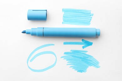 Photo of Different strokes, circle, arrow drawn with light blue marker and highlighter on white background, top view