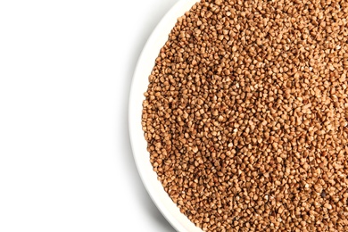 Photo of Bowl with uncooked buckwheat on white background, top view