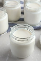Photo of Tasty yogurt on light grey marble table