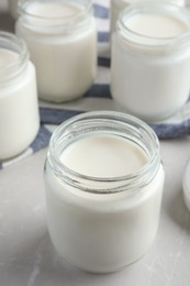 Tasty yogurt on light grey marble table