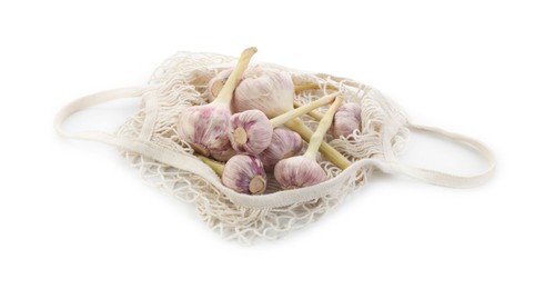 Photo of String bag with garlic isolated on white